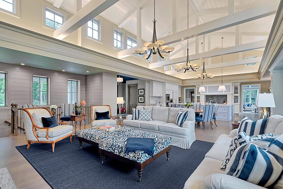 Great room with soaring beamed ceiling overlooking the kitchen and dining area