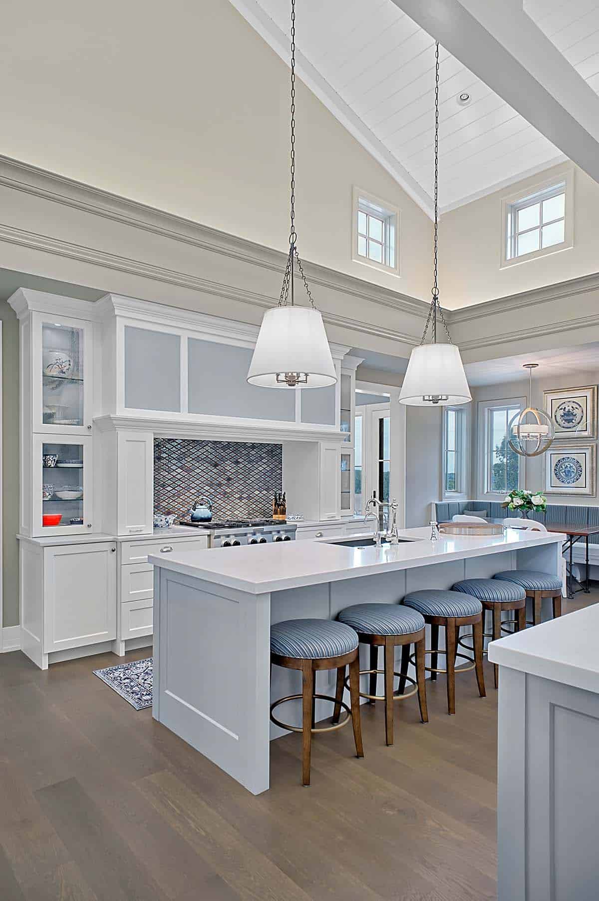 Kitchen range wall with mosaic tile backsplash and blue counter stools