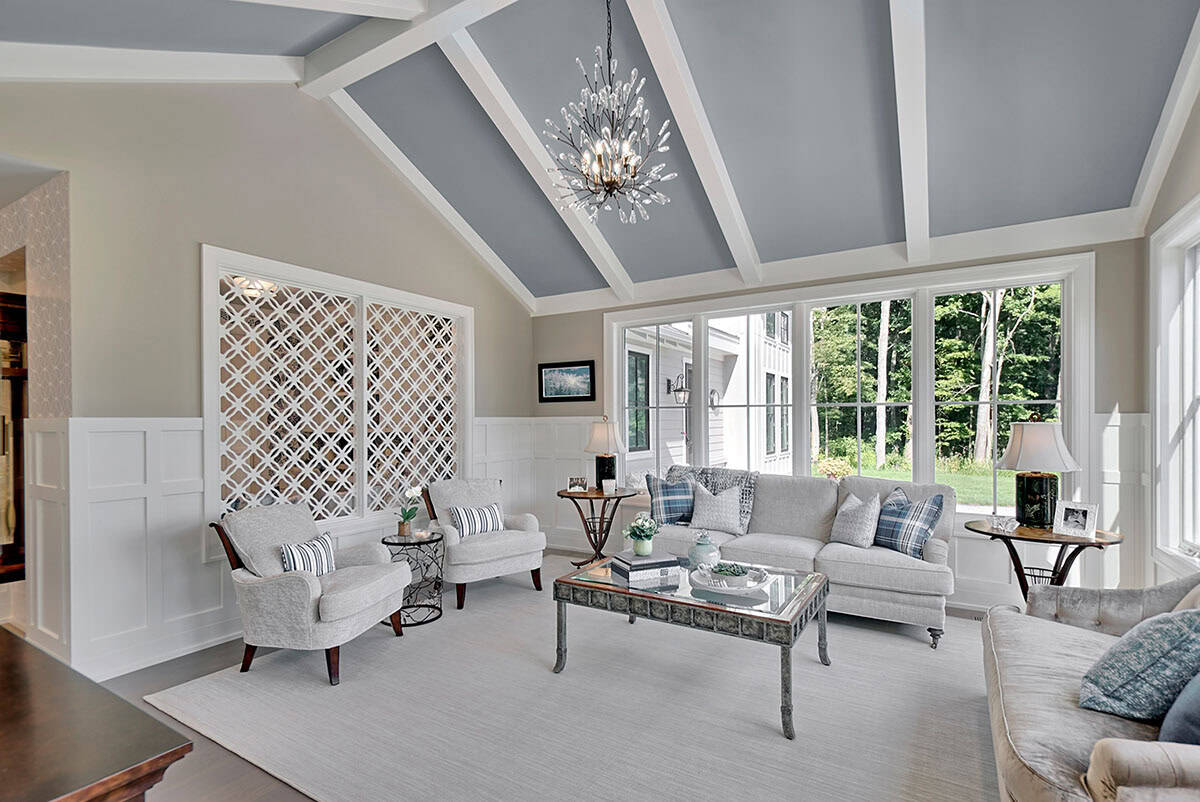 Sunroom seating area with lattice-paneled wall and blue-gray coffered ceiling