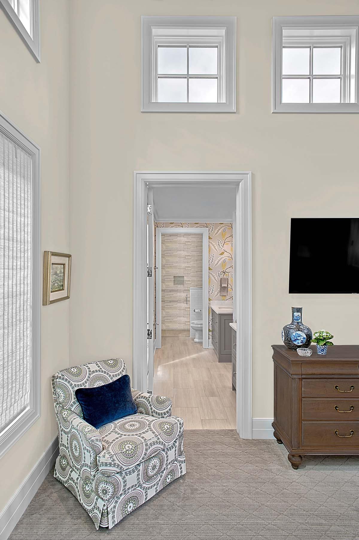 Bedroom sitting corner with a view into an en-suite bathroom
