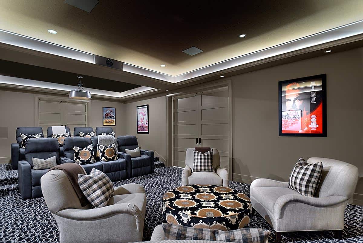 Home theater lounge with upholstered armchairs and a patterned ottoman