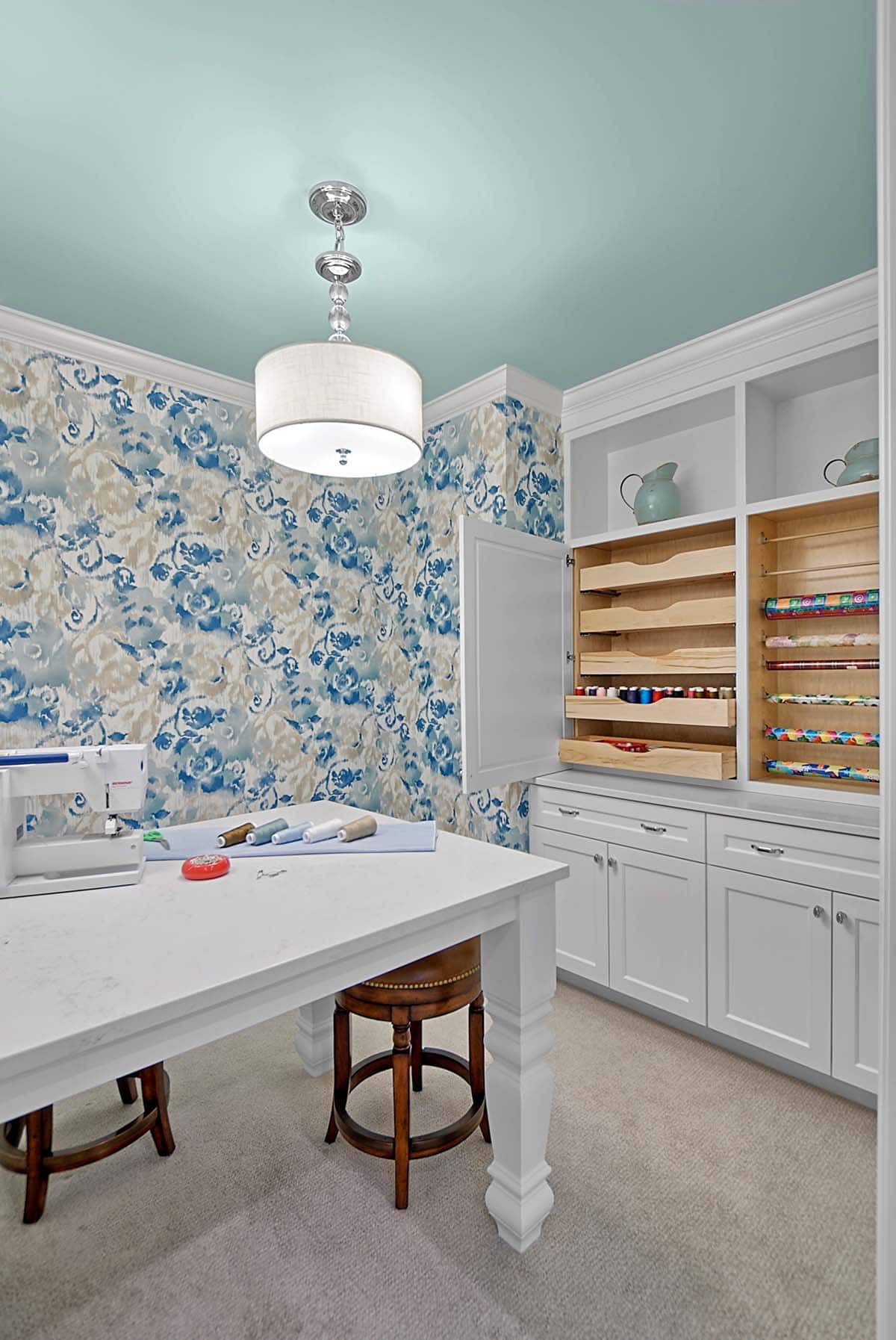 Craft room with pull-out storage drawers and a sewing table