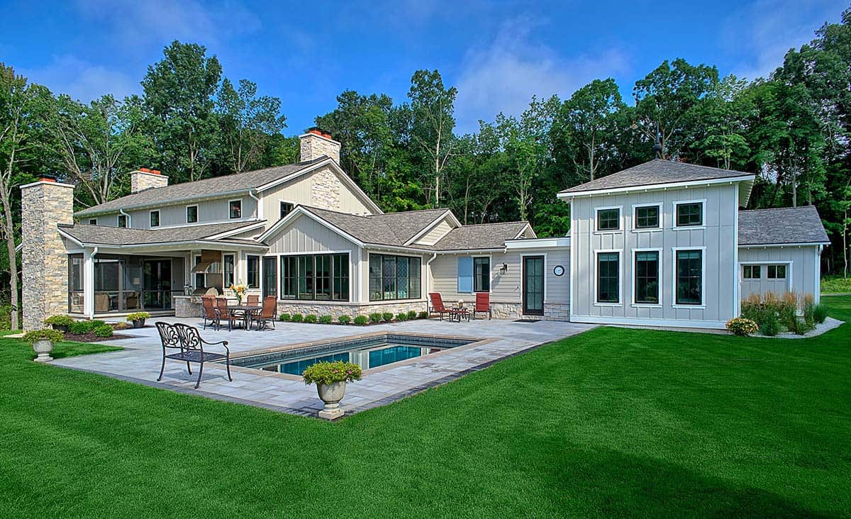 Aerial view of the home's rear exterior with pool and stone patio