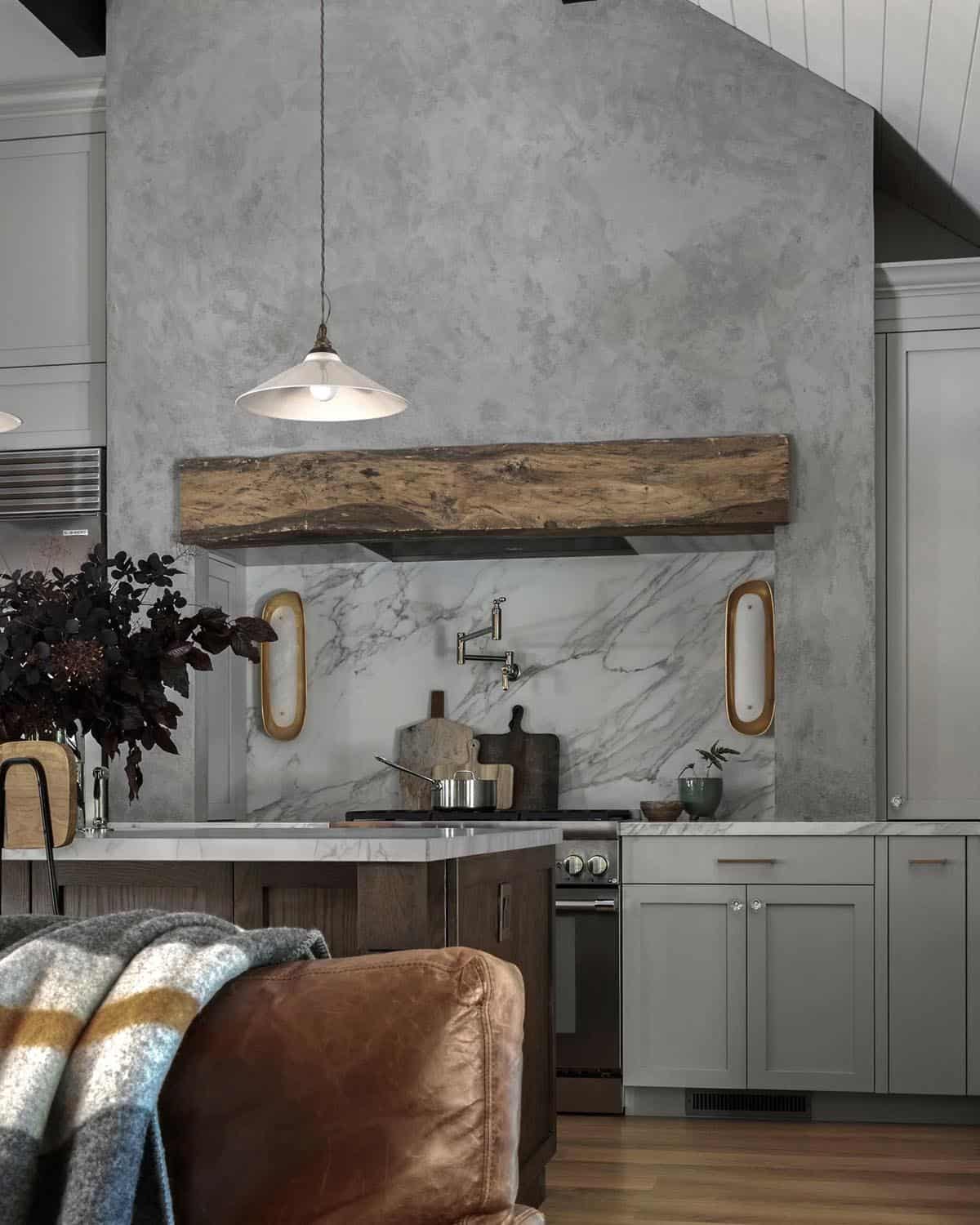 Kitchen range wall with reclaimed wood mantel, marble backsplash, and plaster hood
