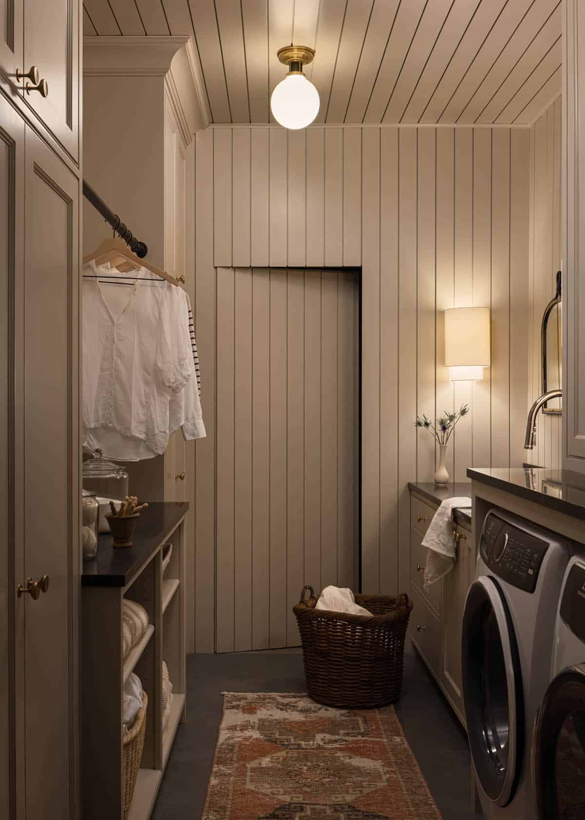 Laundry room with paneled walls, washer and dryer, and woven basket