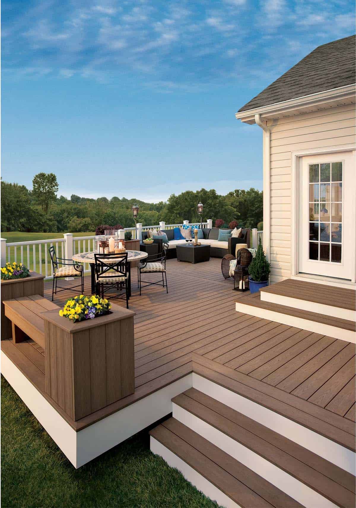 Multi-level Trex composite deck with built-in planters, bench seating, and outdoor dining and lounge areas