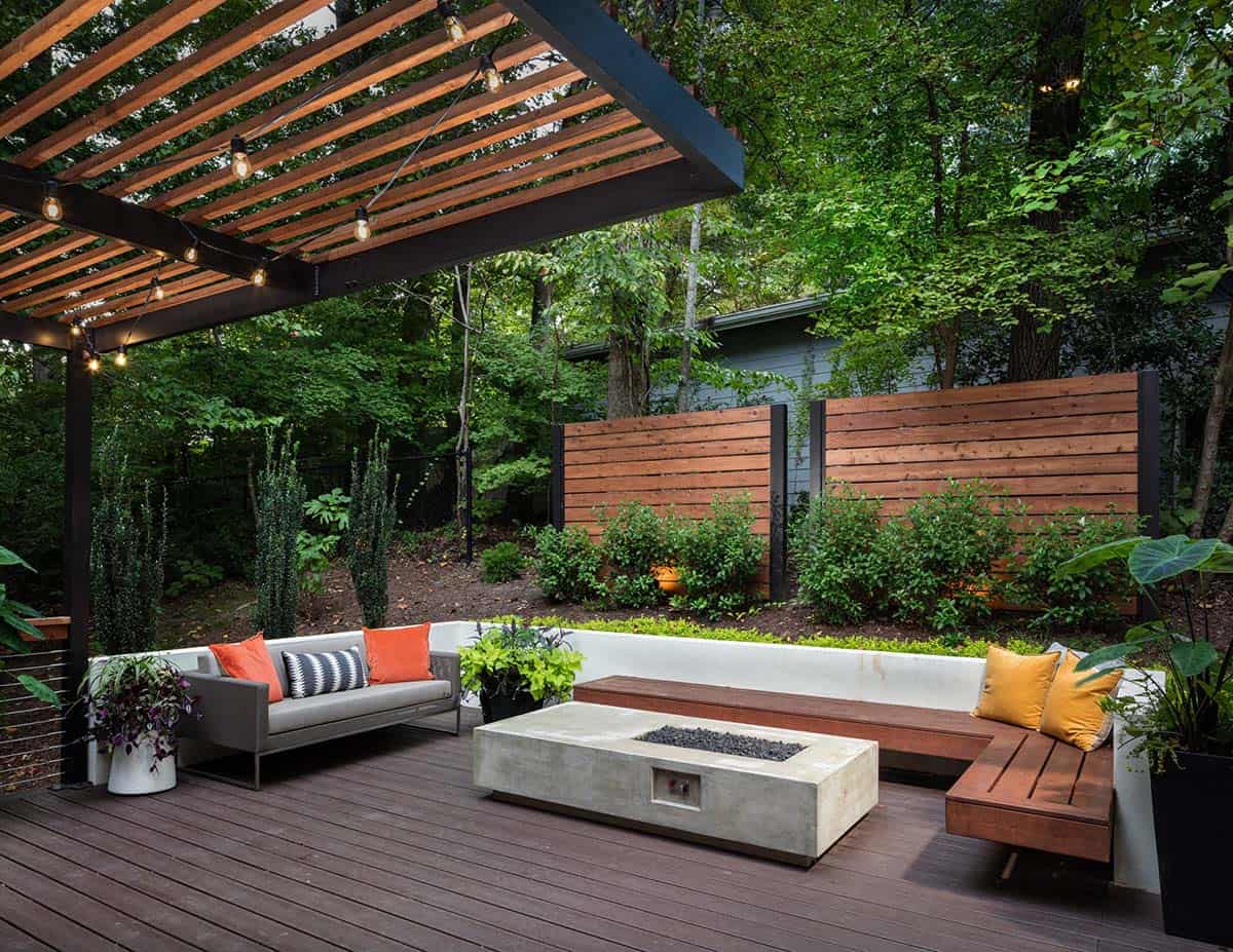 Trex composite deck in Atlanta, Georgia with concrete fire table, floating cedar bench, and pergola