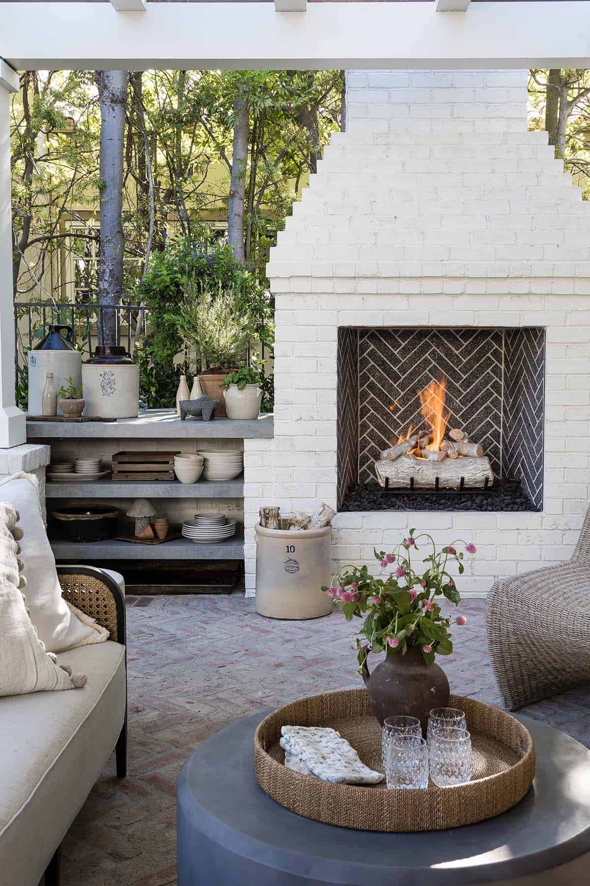 White brick fireplace with dark herringbone-tiled hearth in Orange County