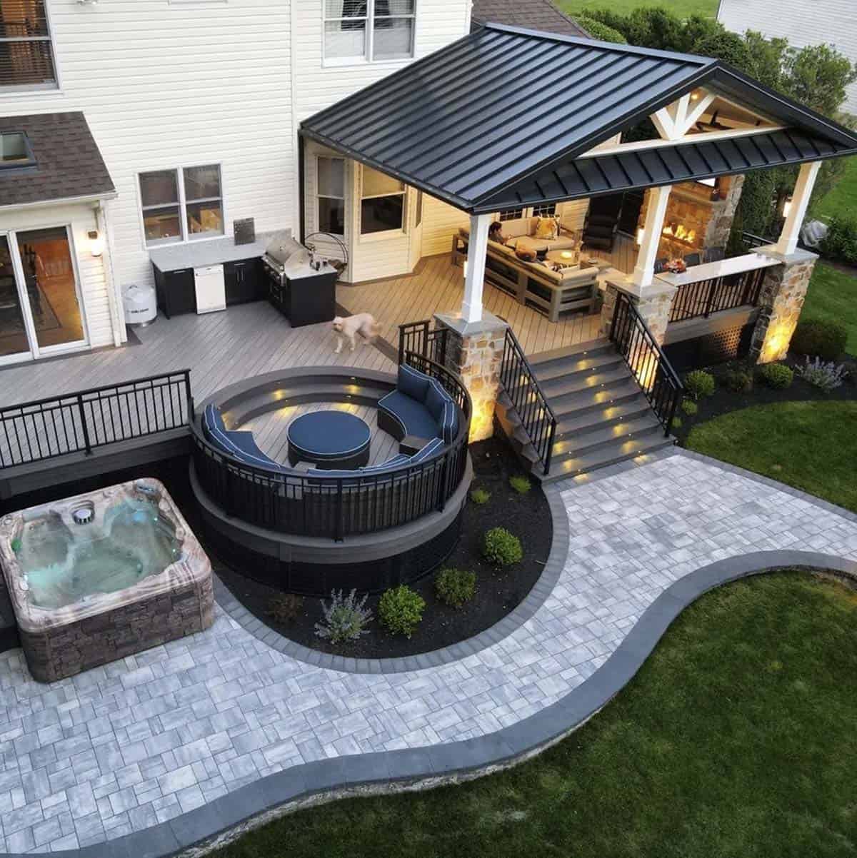 Aerial view of Wolf Serenity composite deck with round fire pit lounge, covered outdoor room, and hot tub