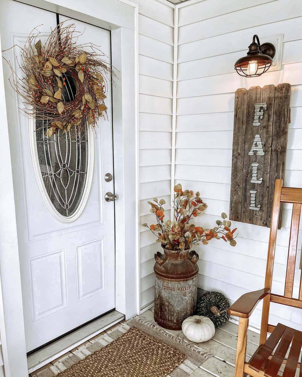 Vintage milk can with fall leaves, pumpkins, and a wooden fall sign