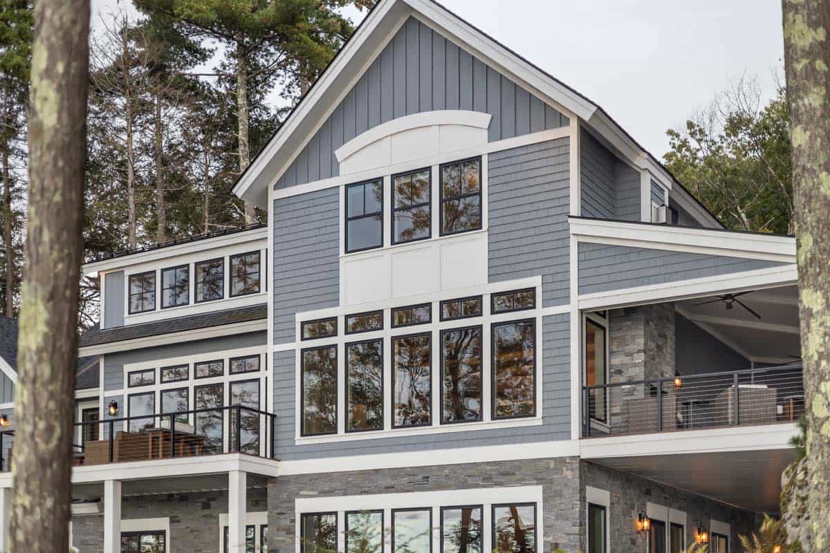 Shingle and board-and-batten gable with black-framed windows and covered deck