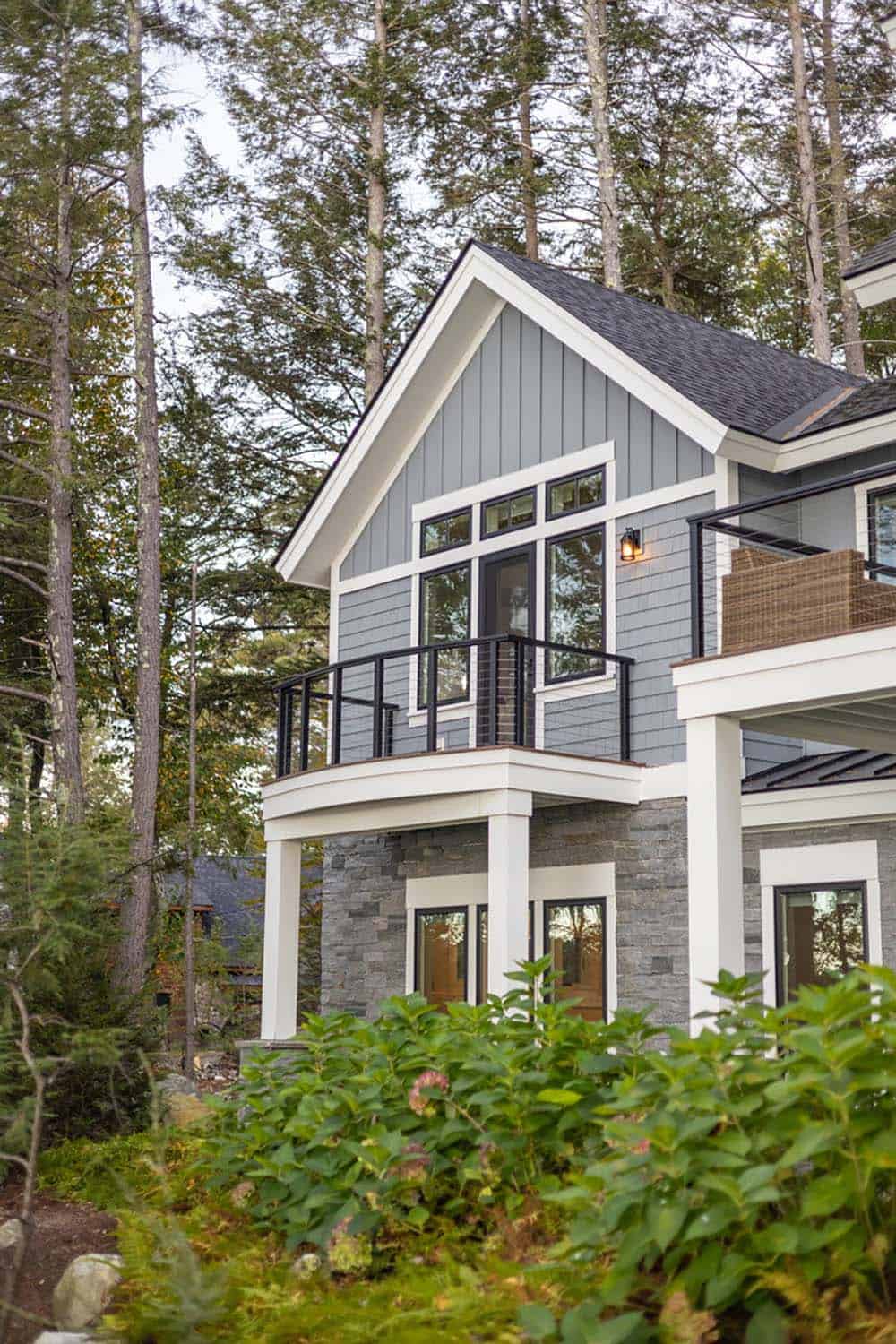 Curved balcony with cable railing off a gabled upper bedroom