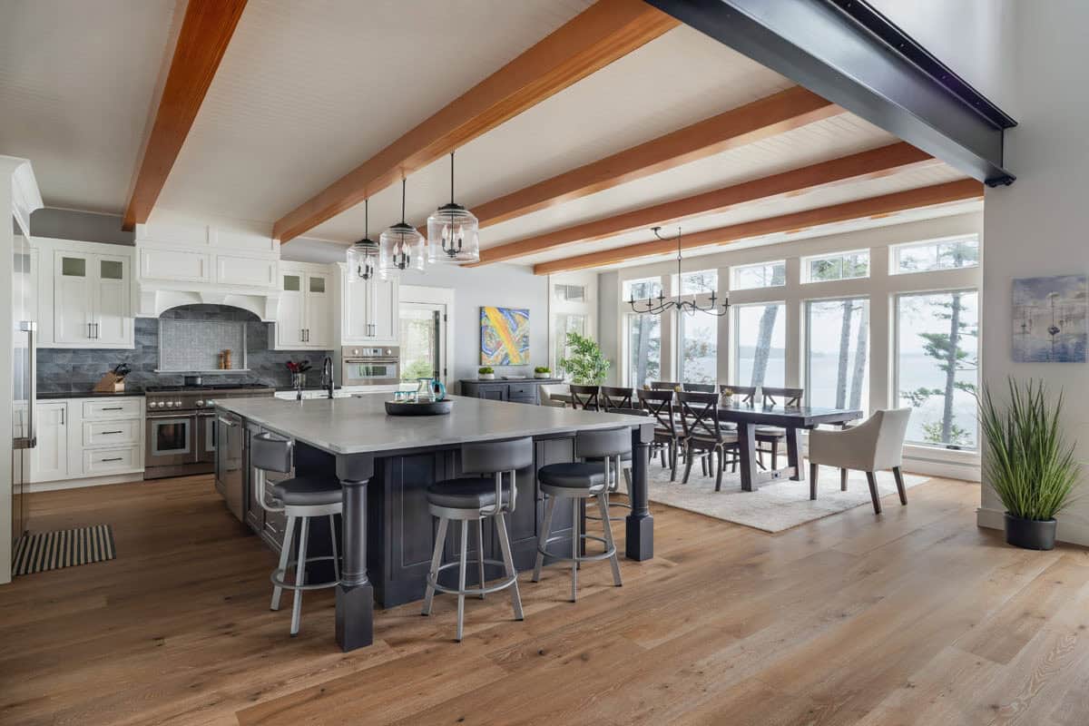 Open kitchen and dining area with exposed beams and lake views