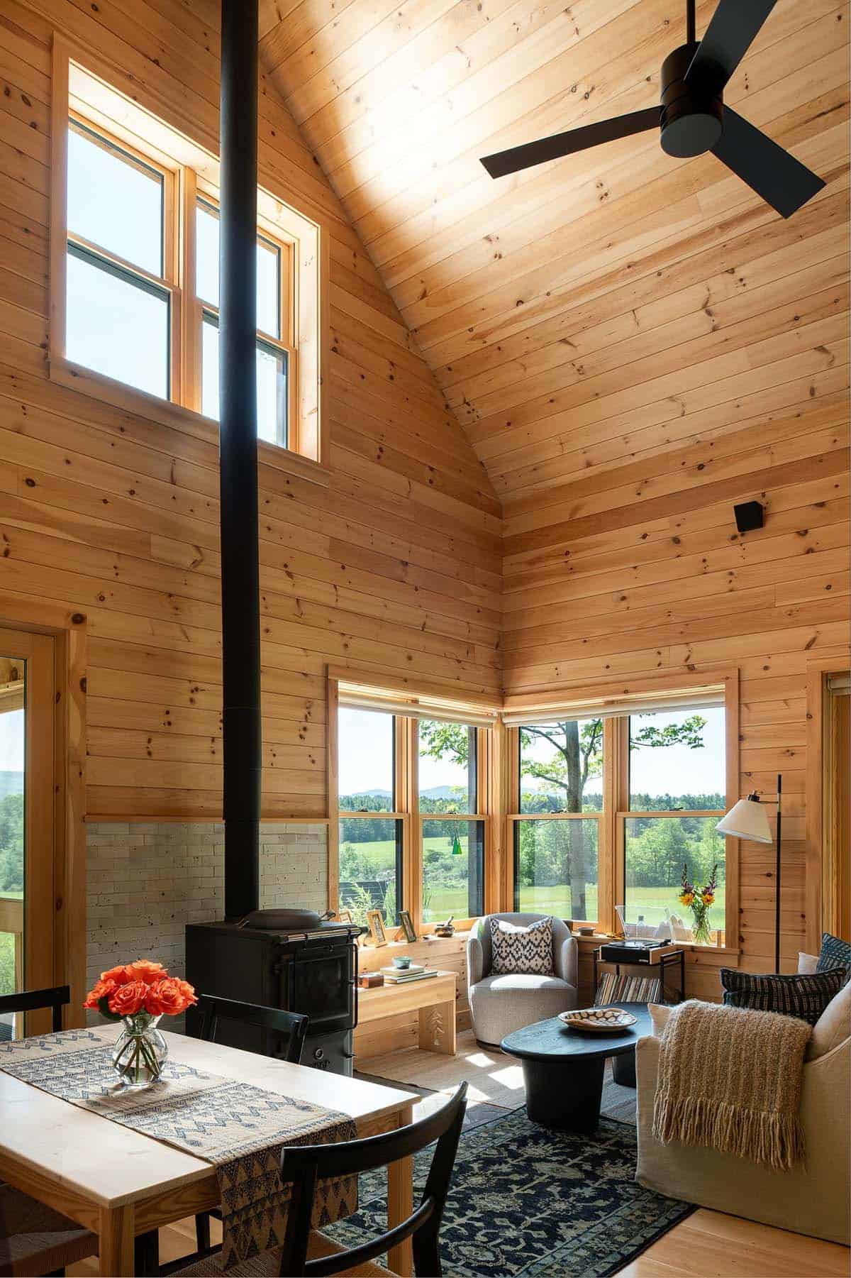 Vaulted living room ceiling with black stovepipe and corner windows