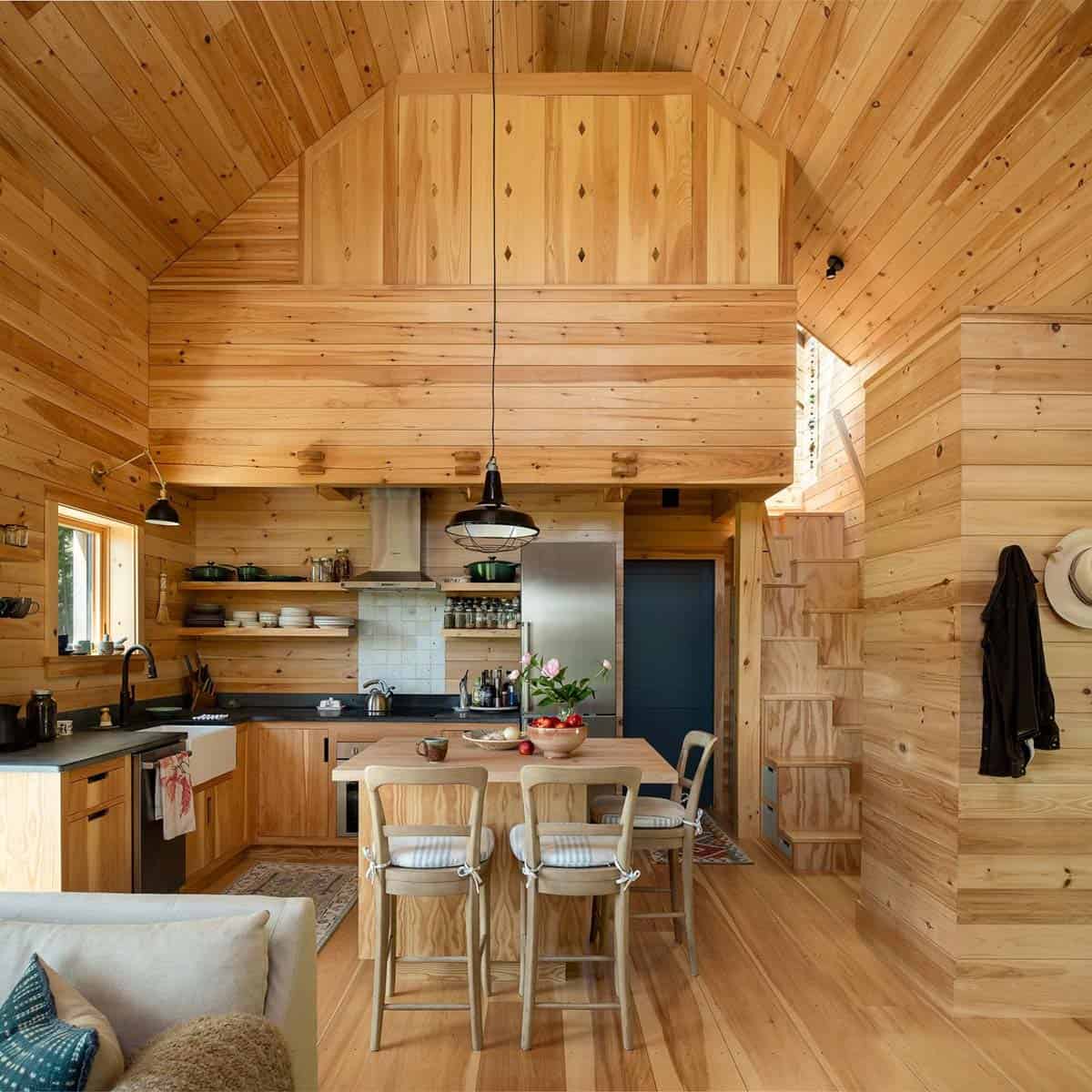 Kitchen island beneath a loft with diamond-accent wood panels