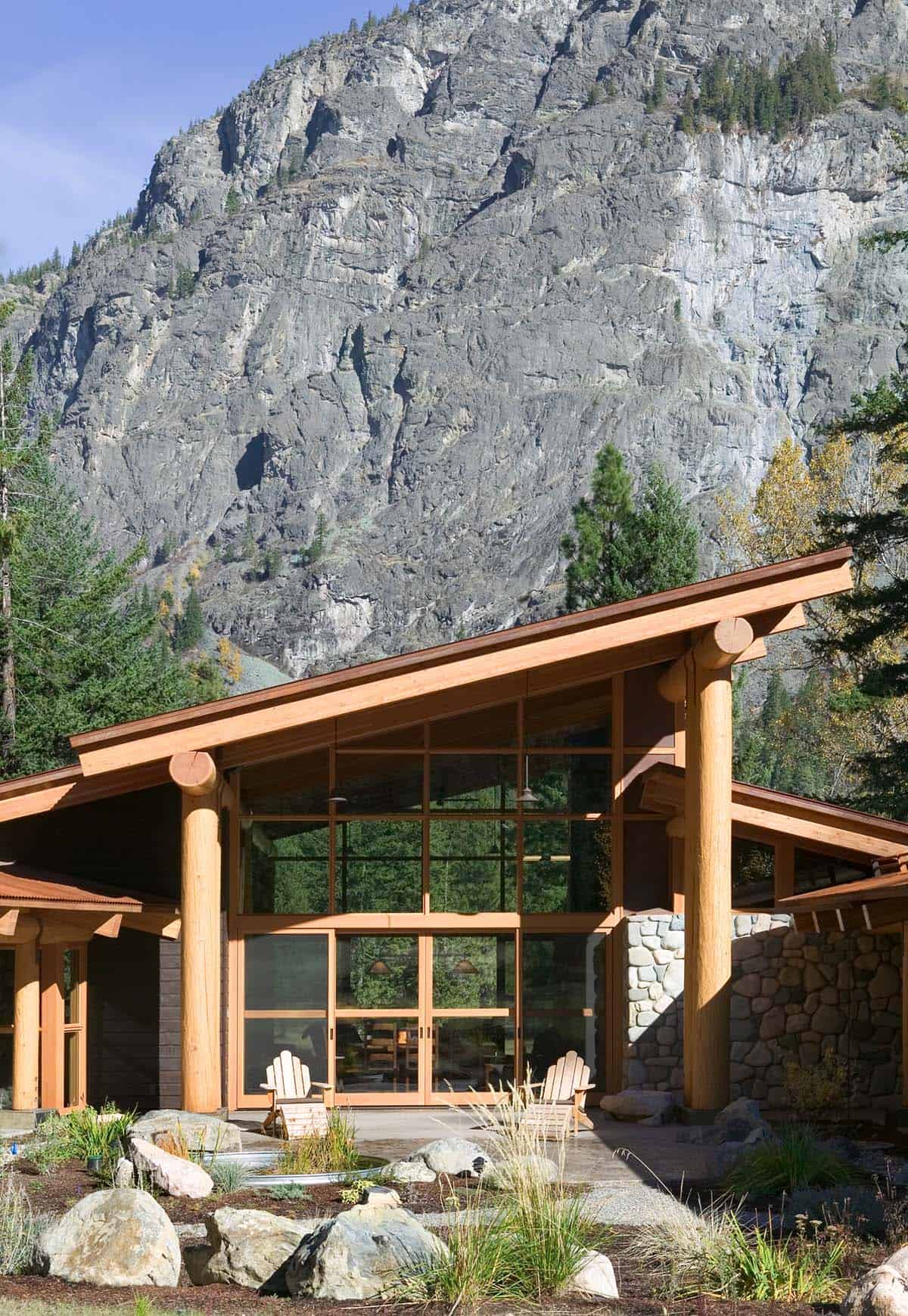 Covered patio with Adirondack chairs framed by log posts and cliff