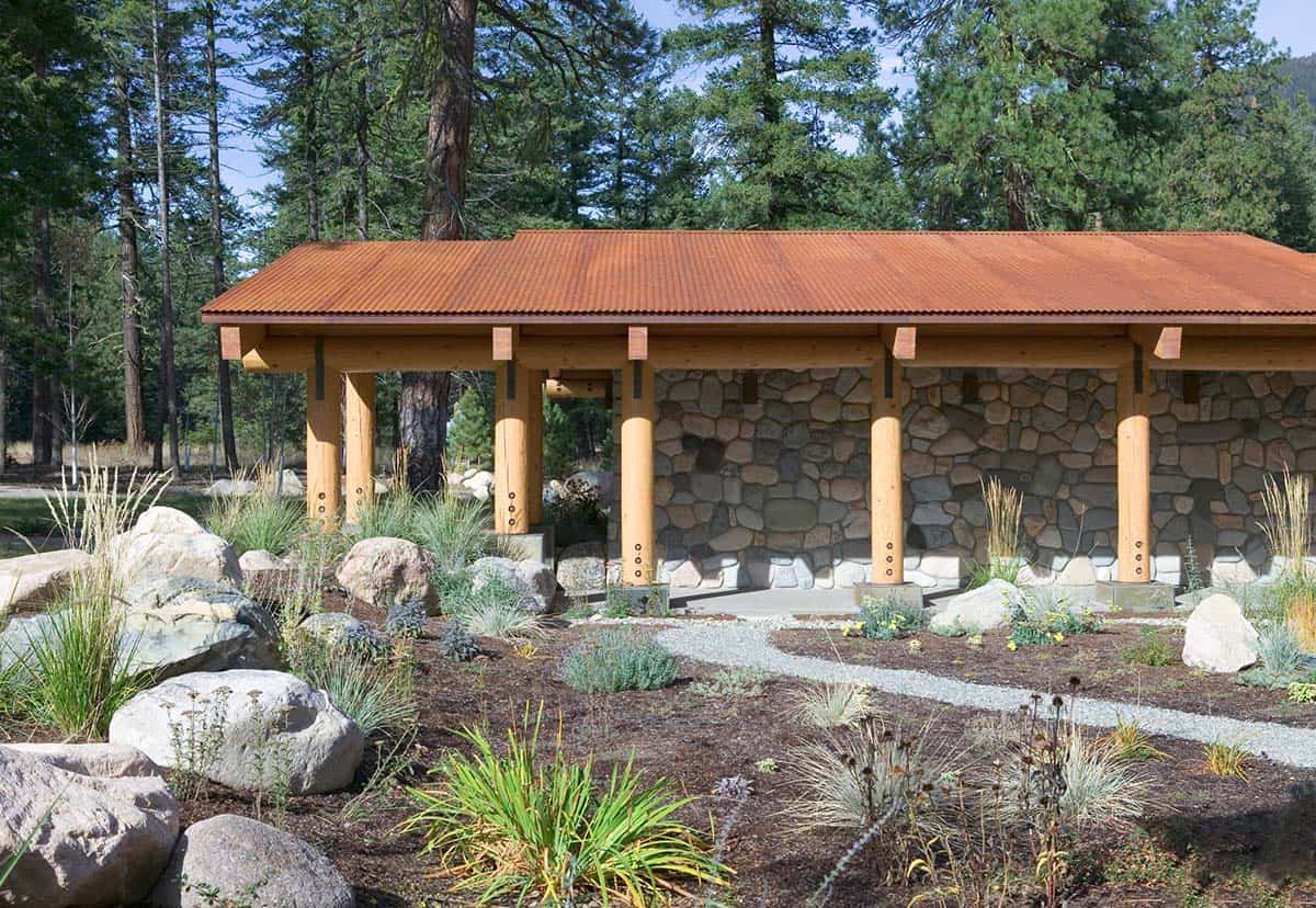 Bunkhouse exterior with corrugated copper roof and river stone base