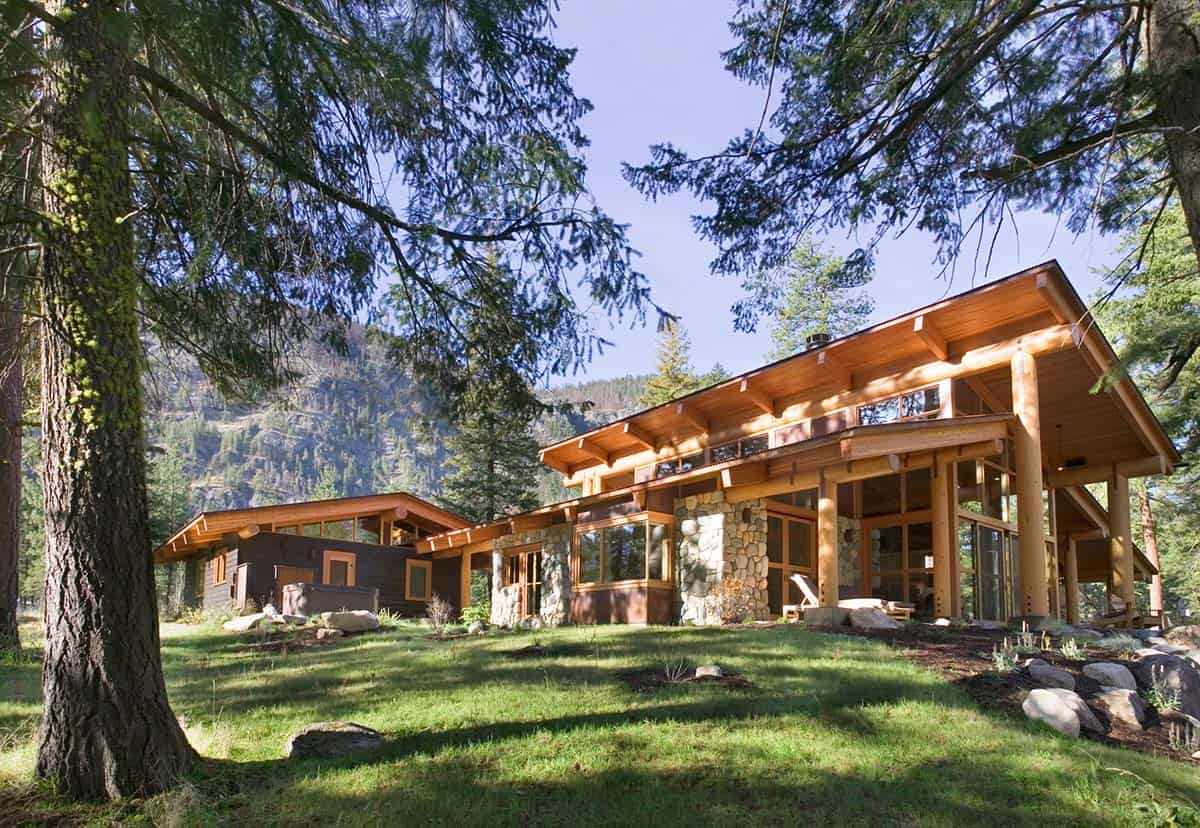 Wide view of connected buildings surrounded by forest and open lawn