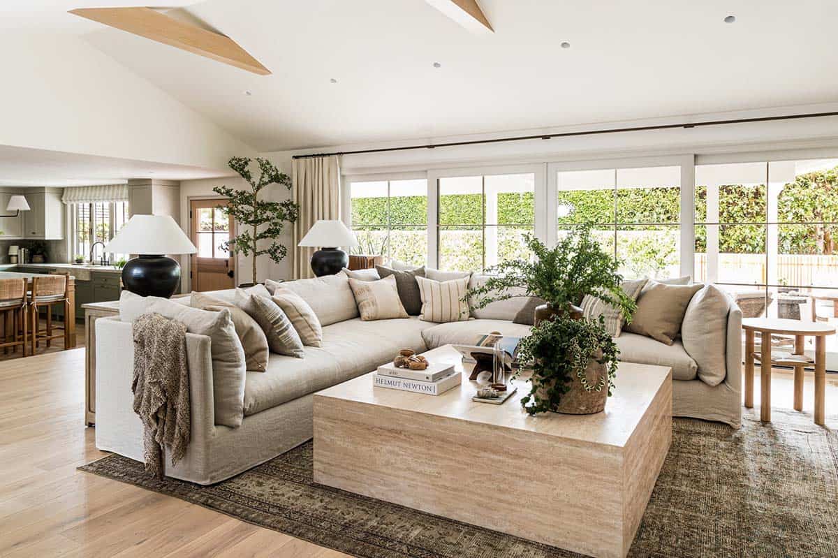 Vaulted living room with linen sectional and travertine coffee table
