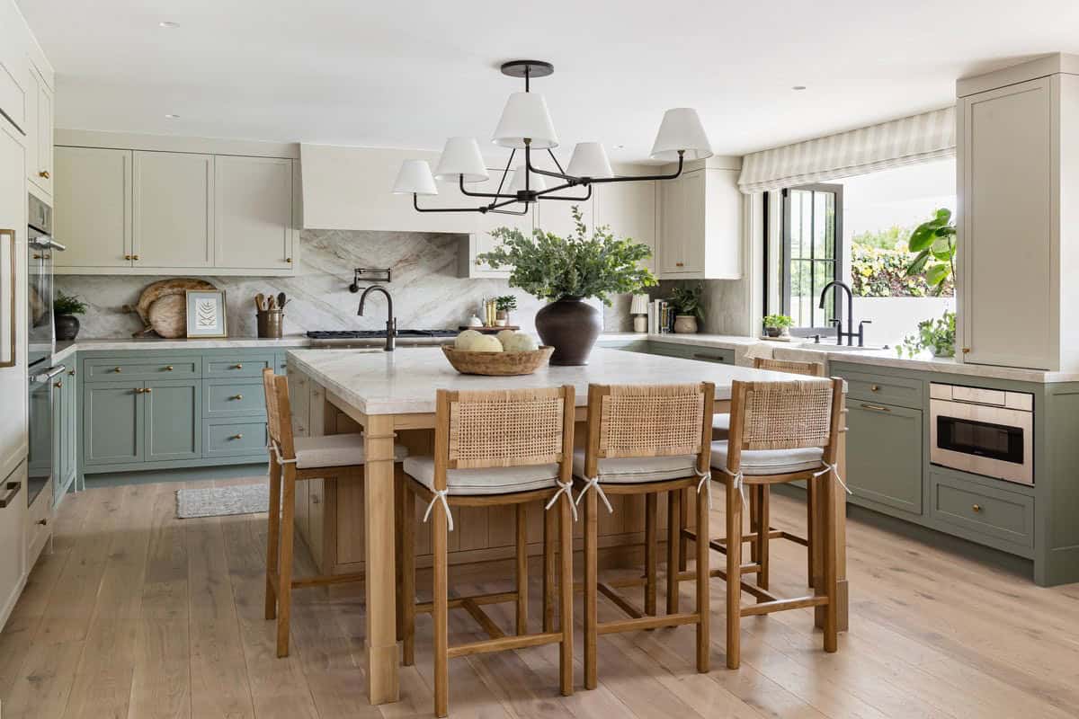 Kitchen with striped roman shade and dual-tone green cabinetry