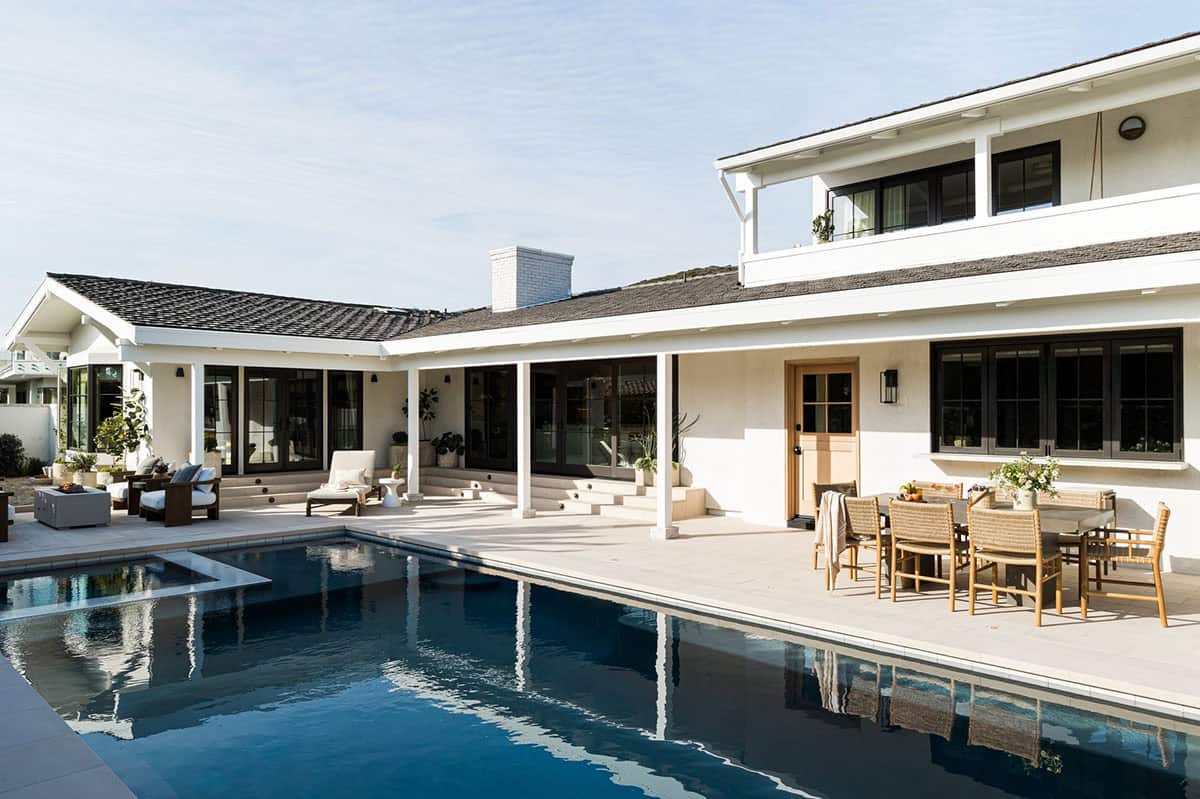 Rear exterior with pool, covered patio and second-story balcony