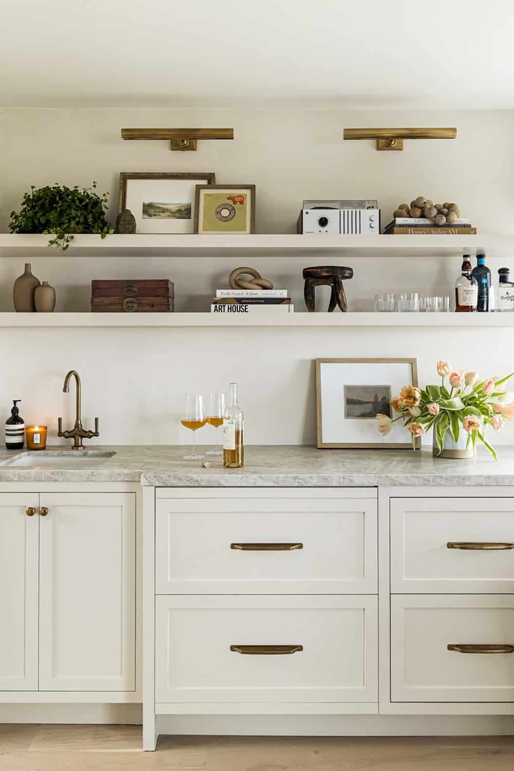 Bar shelving styled with art, books and glassware display