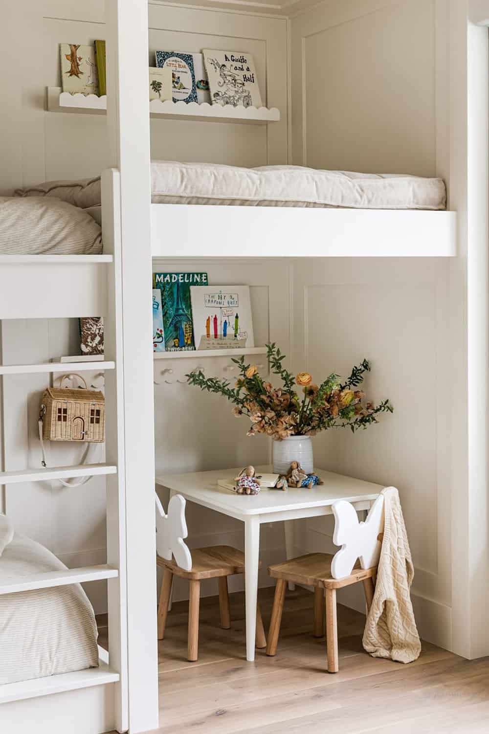 Built-in bunk nook with bookshelf and children's play table