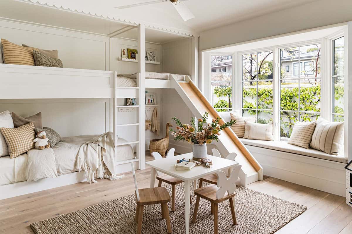 Built-in bunk beds with wood slide and bay window seat