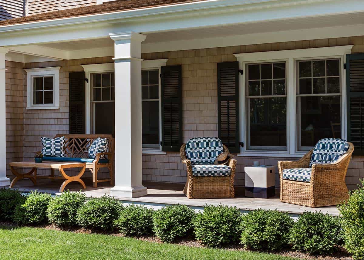 Front porch with wicker chairs in blue patterned cushions