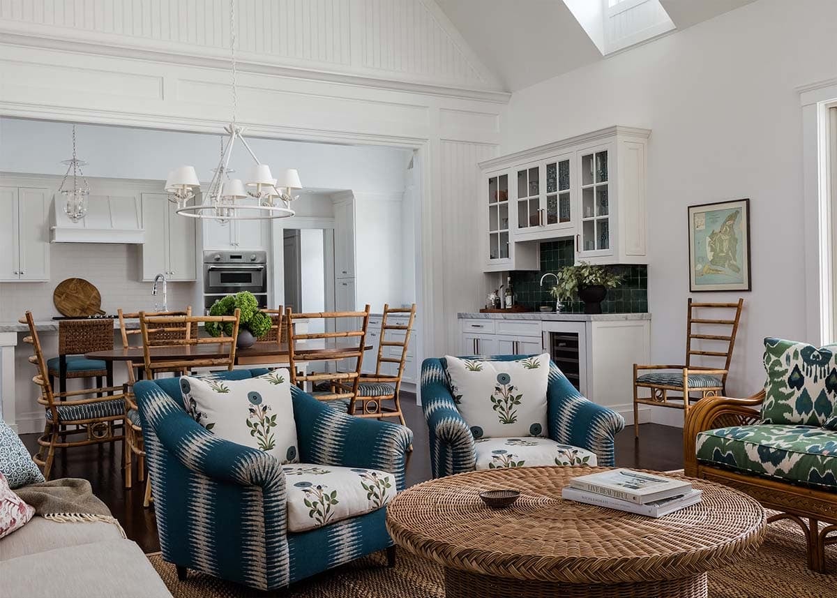 Open living and dining area with teal ikat armchairs