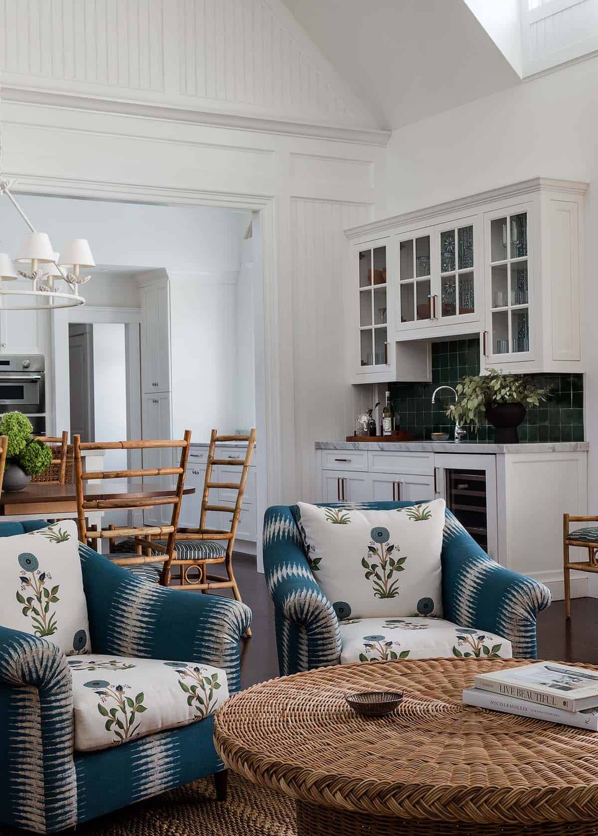 Living room chairs facing a green tile wet bar