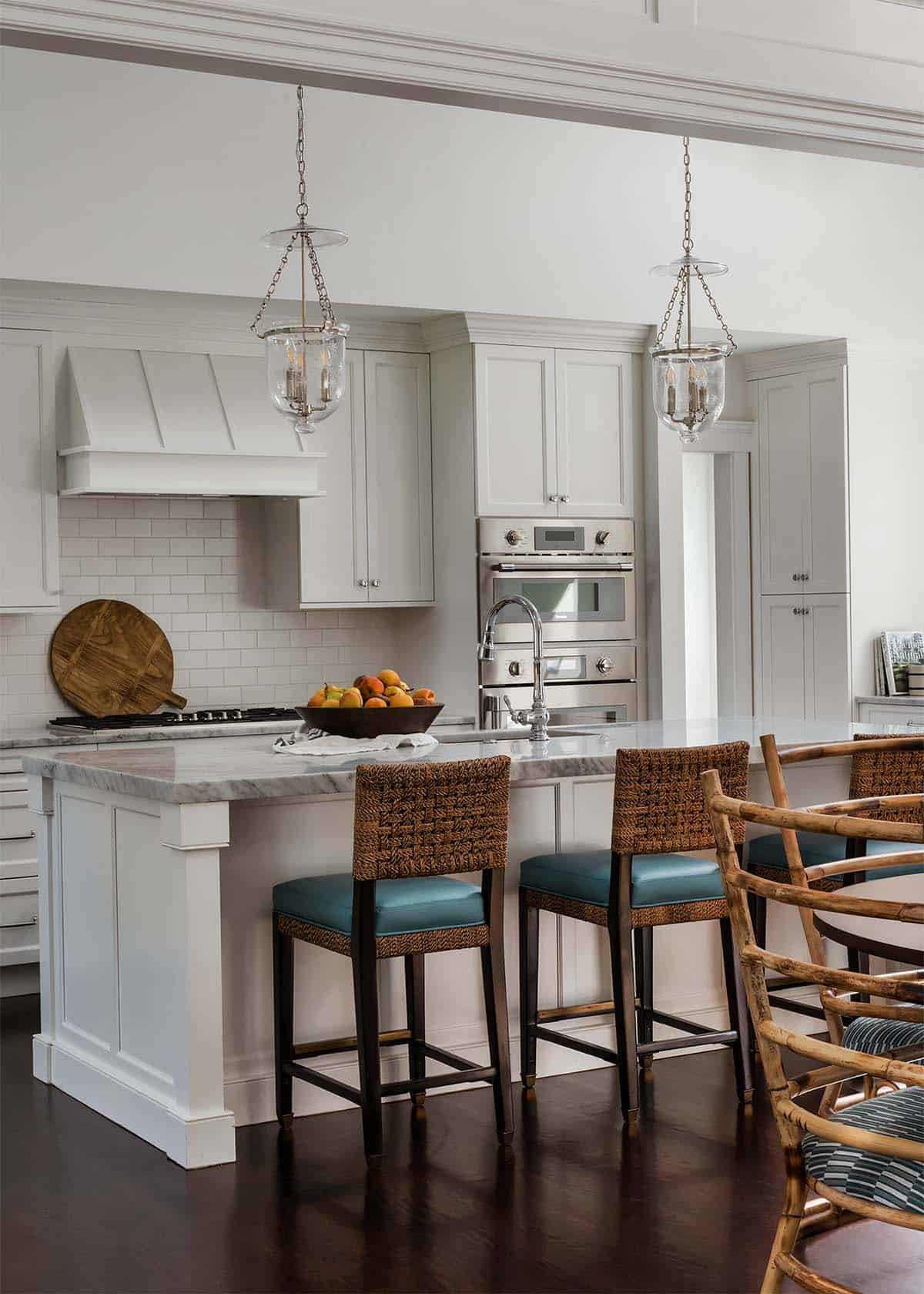 Kitchen island with woven counter stools and marble top