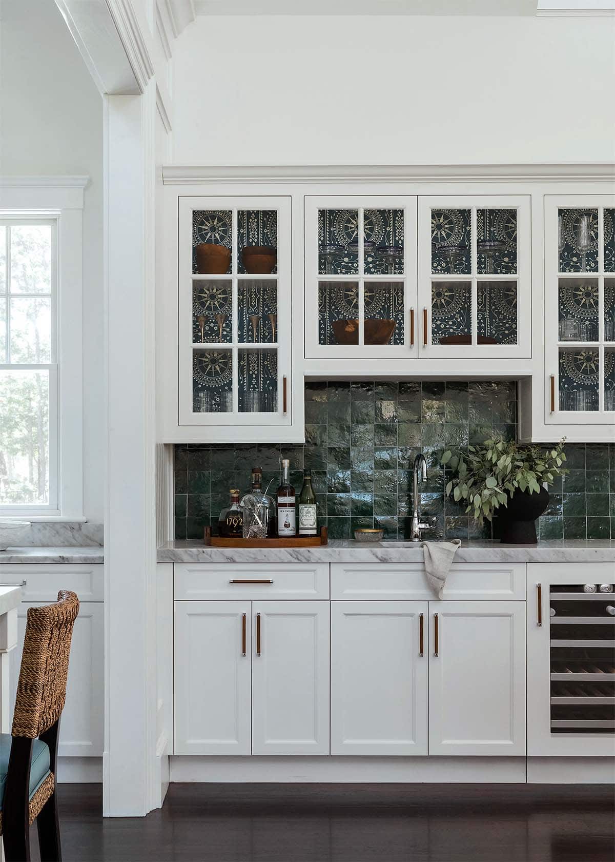 Wet bar cabinets with patterned interiors and green tile backsplash