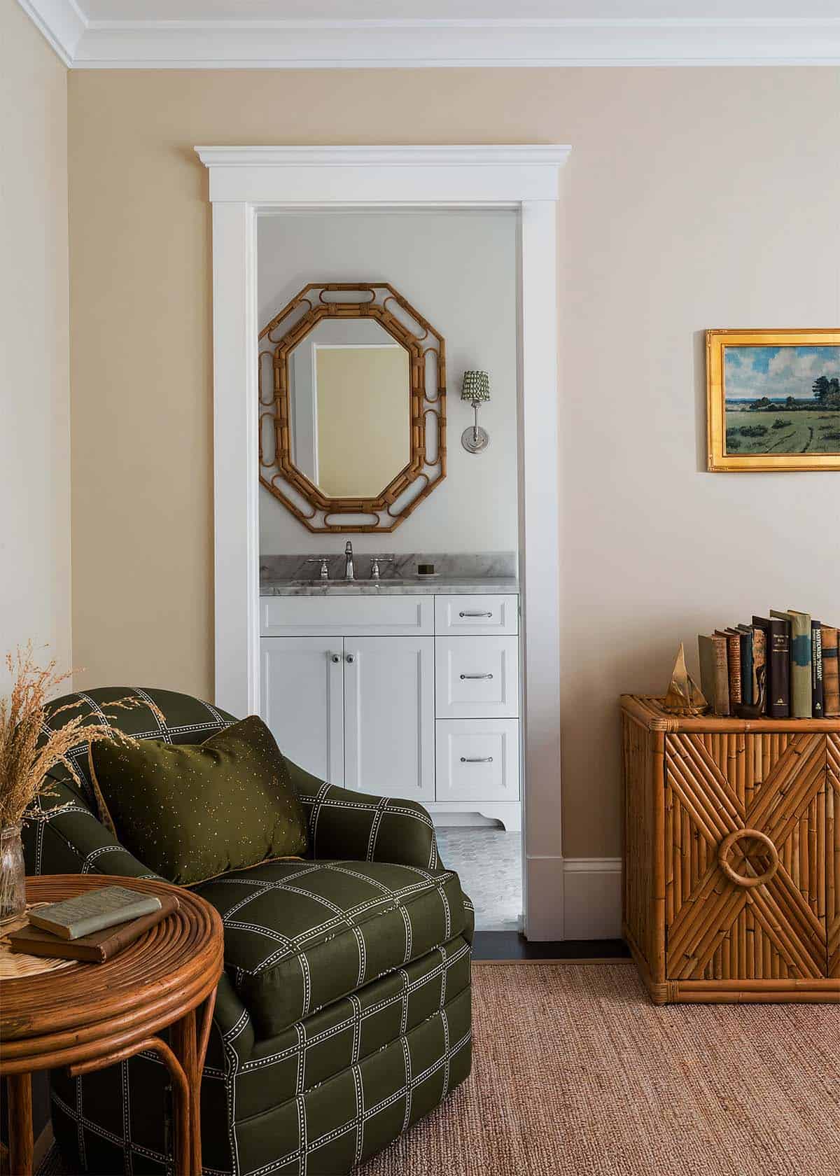 Sitting area with plaid armchair and view into ensuite bath