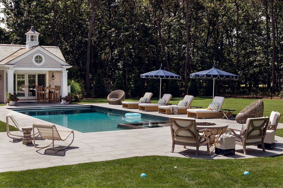 Pool deck with lounge chairs and scalloped navy umbrellas