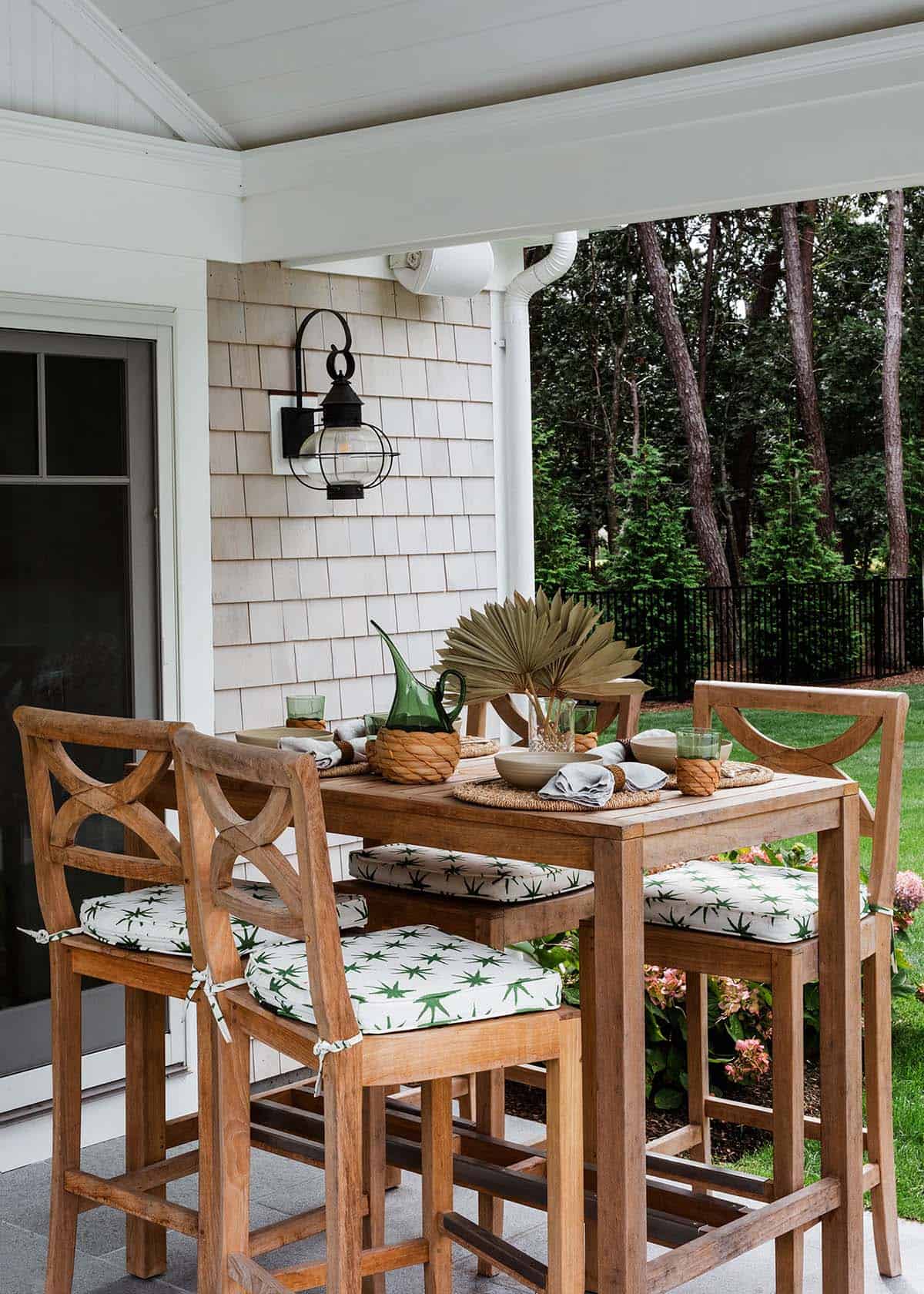 Outdoor bar dining table set with palm frond centerpiece