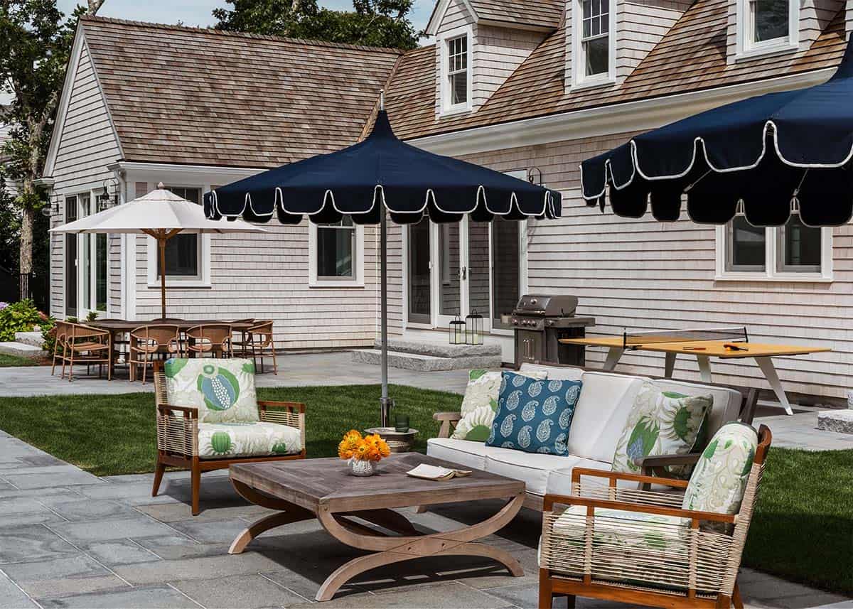 Backyard patio with navy umbrellas and ping pong table