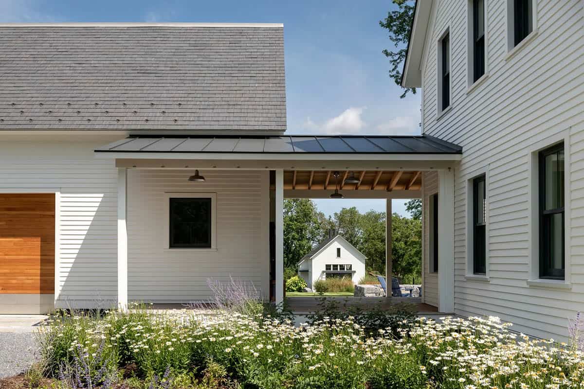 Covered breezeway with standing seam metal roof connecting the garage and main house
