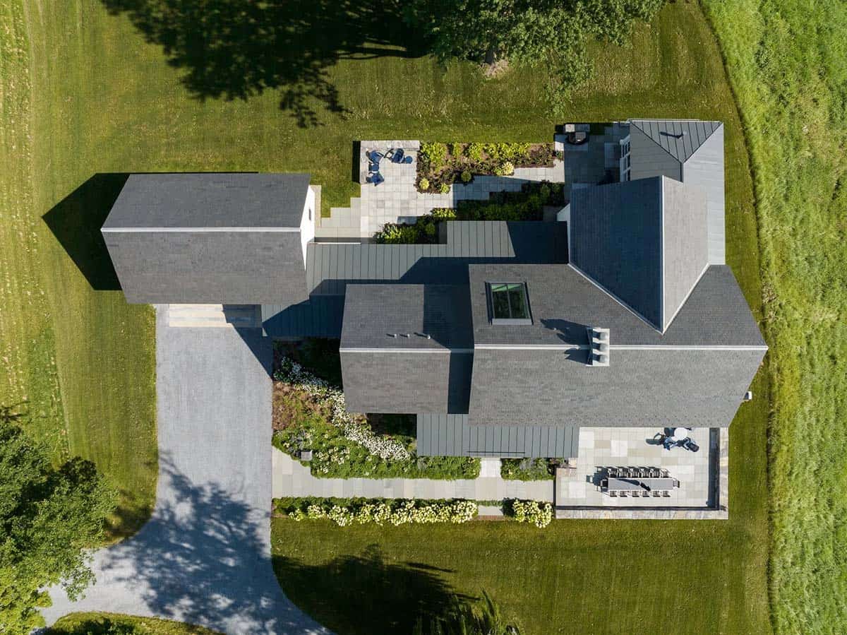 Aerial view of the Vermont farmhouse with slate roofs, bluestone patios, and gravel drive