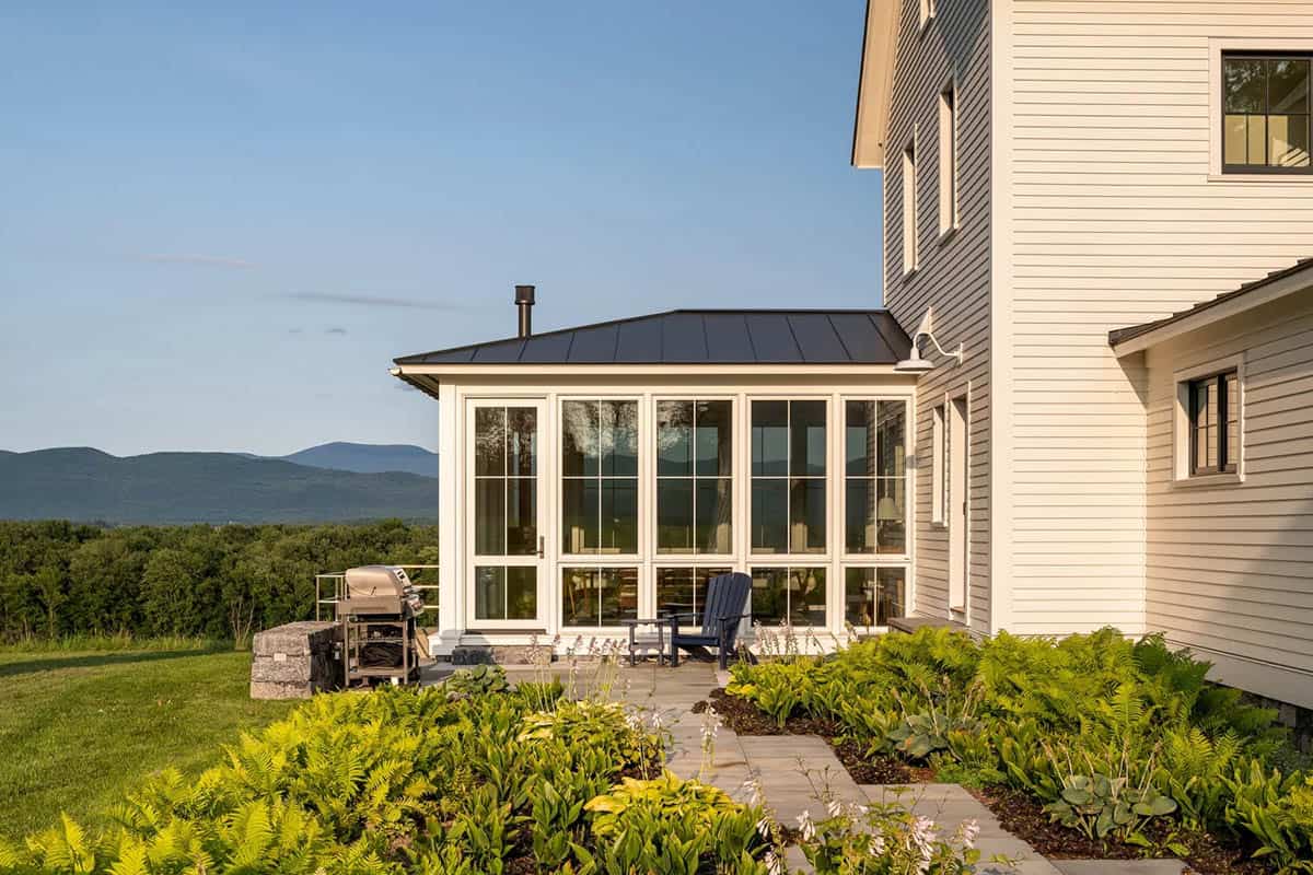 Sunroom terrace with bluestone path, ferns, hostas, and mountain views