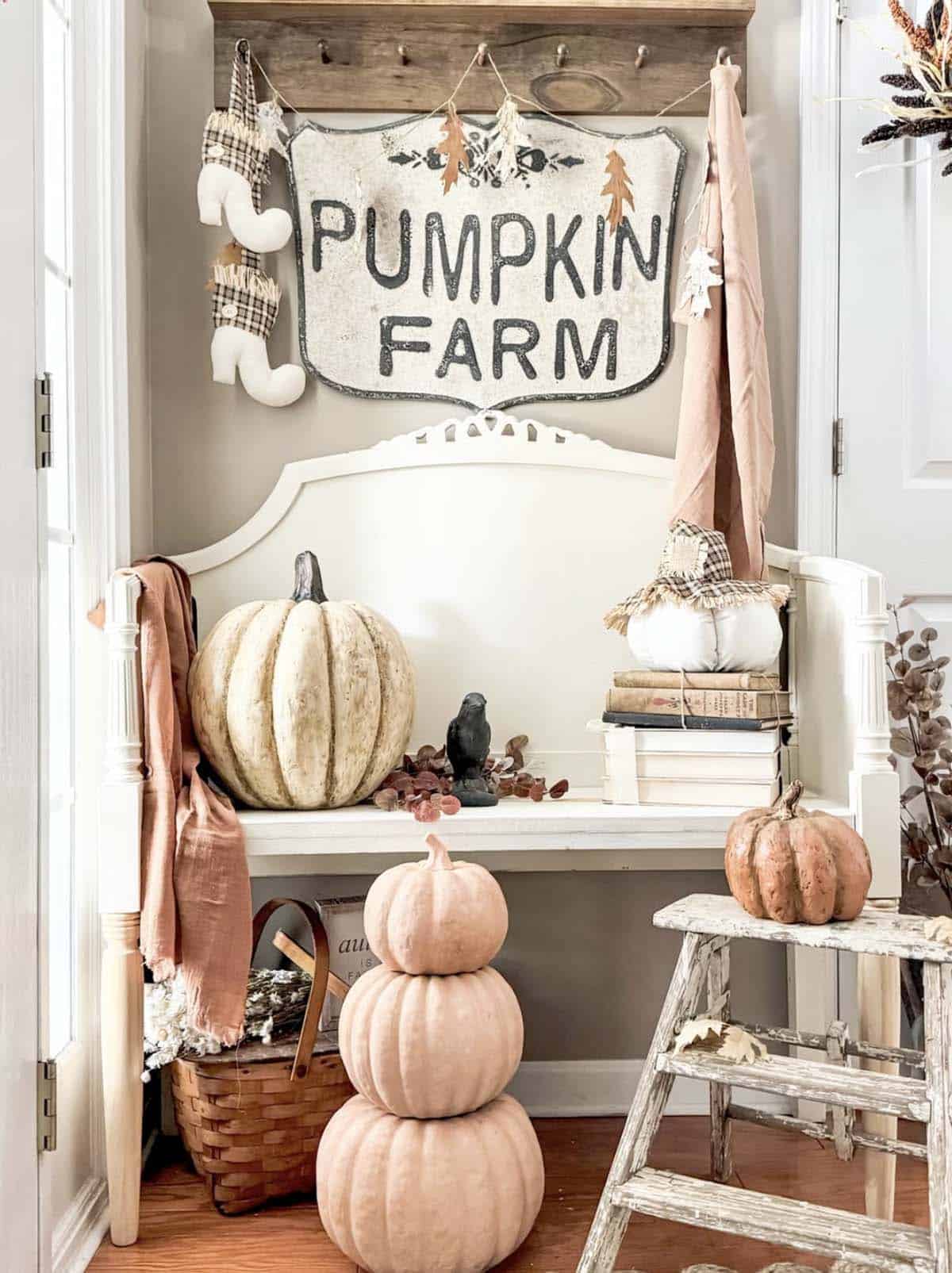 Bench nook styled with a vintage Pumpkin Farm sign and pumpkins