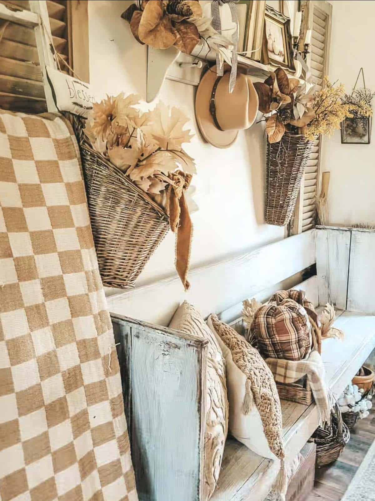 Wicker wall baskets filled with fall leaves above an entryway bench