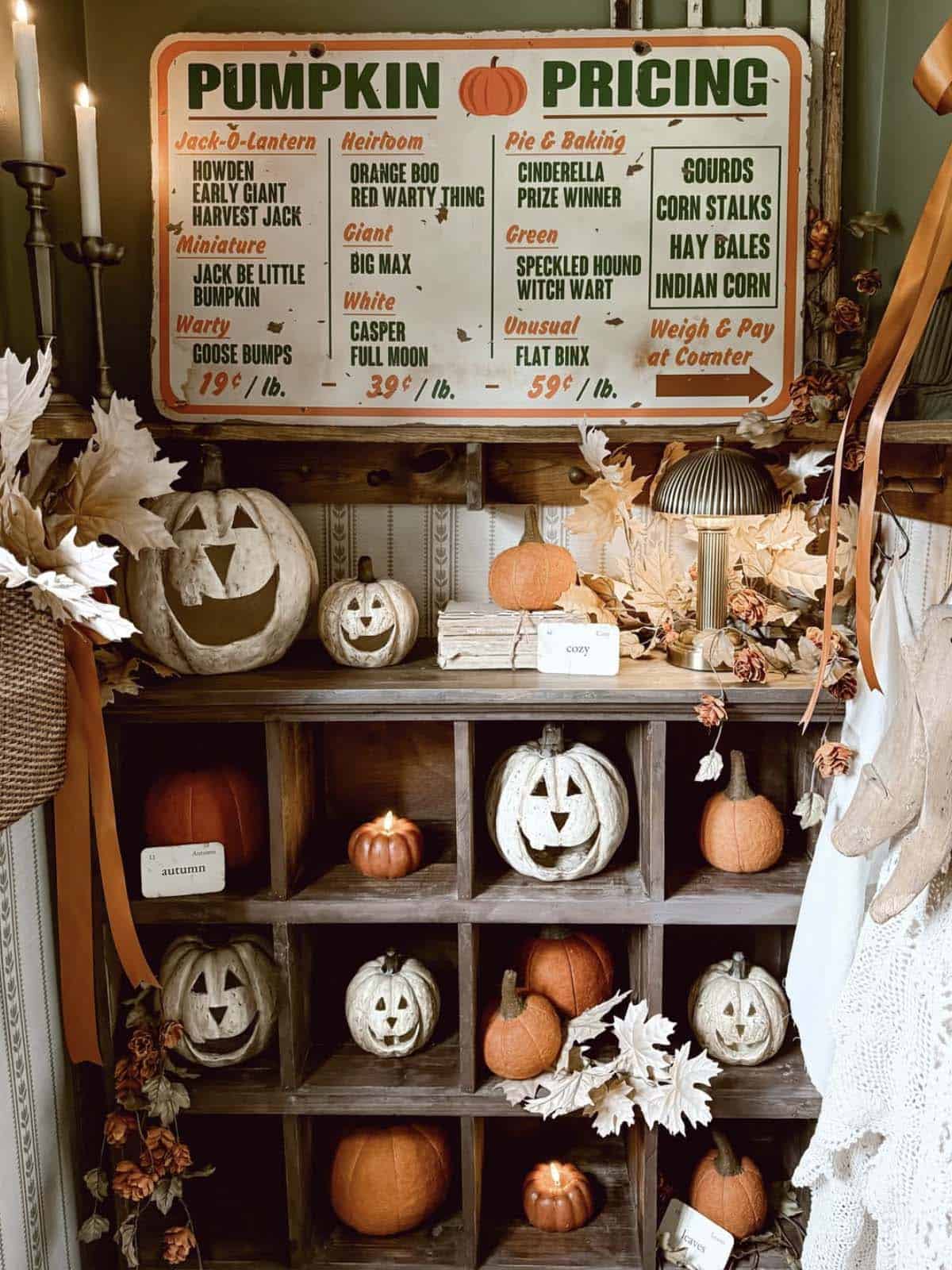 Vintage pumpkin pricing sign above a jack-o'-lantern cubby shelf