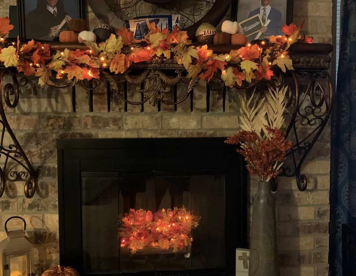 Fireplace mantel and hearth lined with pre-lit garland