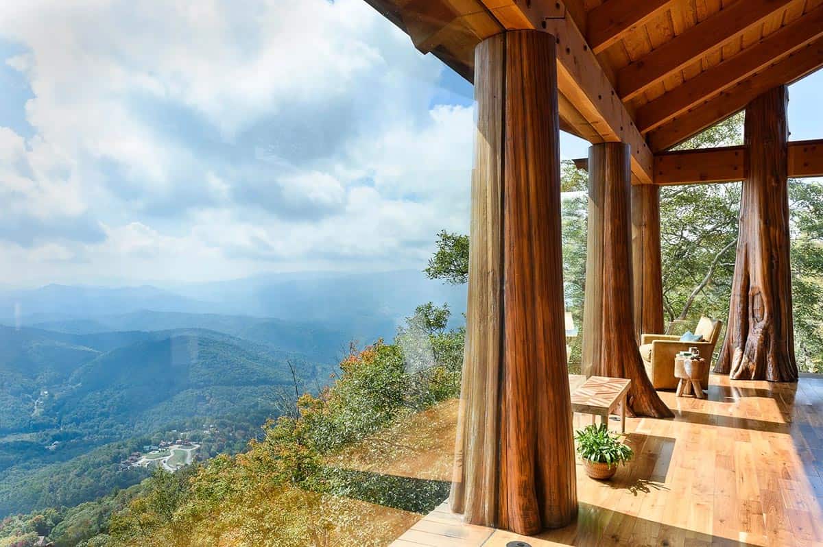 Covered deck with tree trunk columns overlooks a Blue Ridge Mountains valley