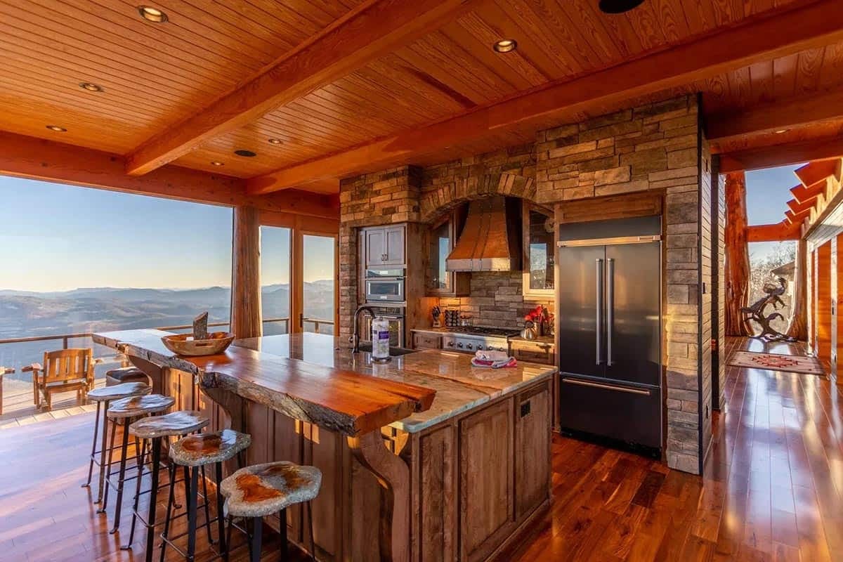 Kitchen island with live edge wood counter and stone hood surround