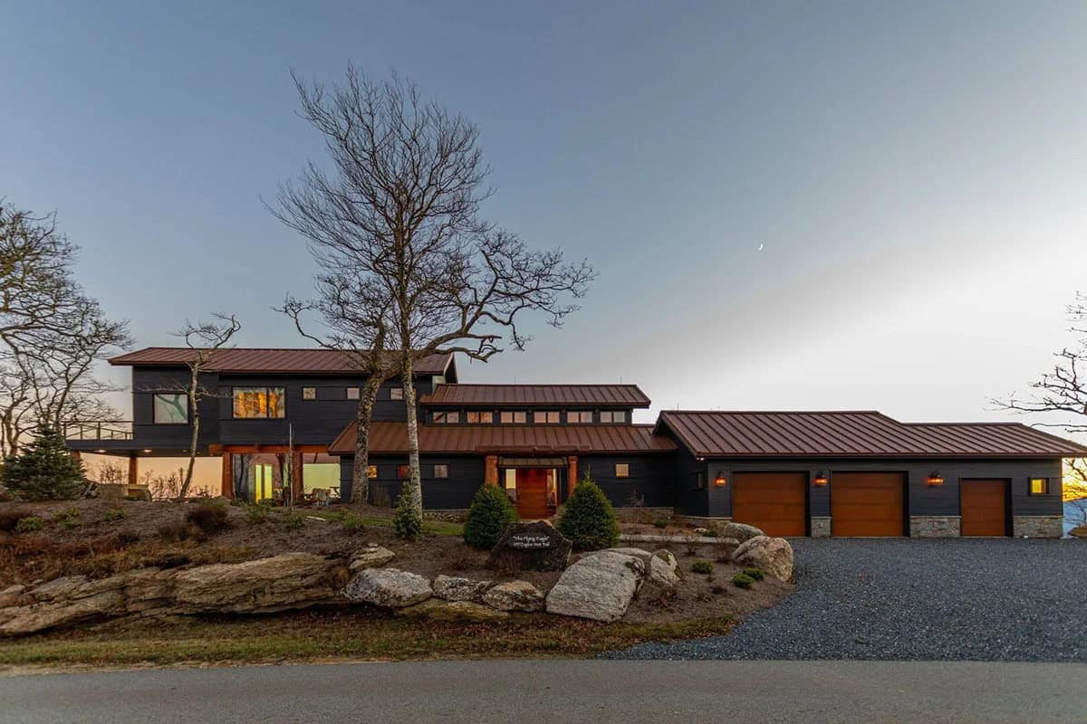 Timber home with copper standing seam roof and three car garage