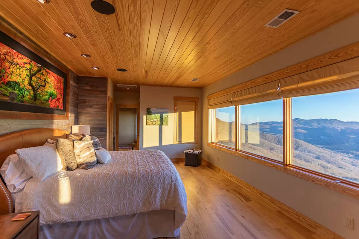 Primary bedroom with leather headboard and mountain view windows