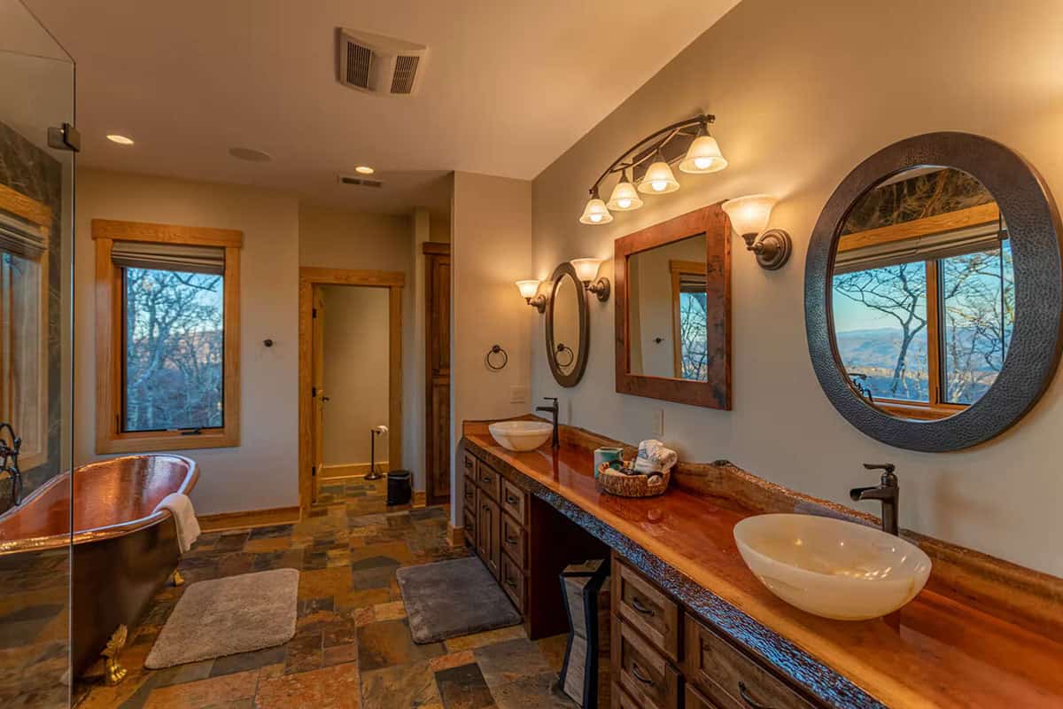 Primary bathroom vanity with vessel sinks and round mirrors