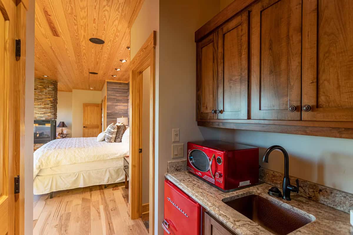 Kitchenette with red retro microwave and mini fridge near a bedroom